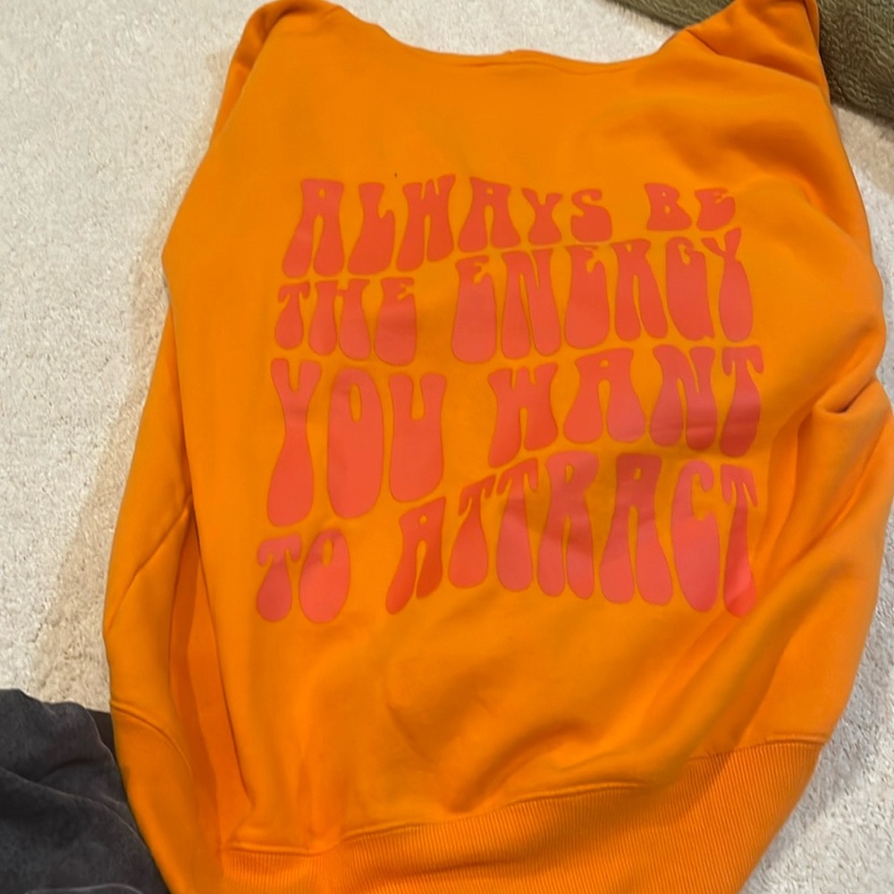 Orange zip up from pacsun with graphic writing on the back